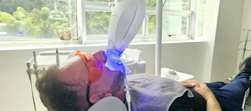 Patient during a Philips Zoom whitening session with the LED lamp in place